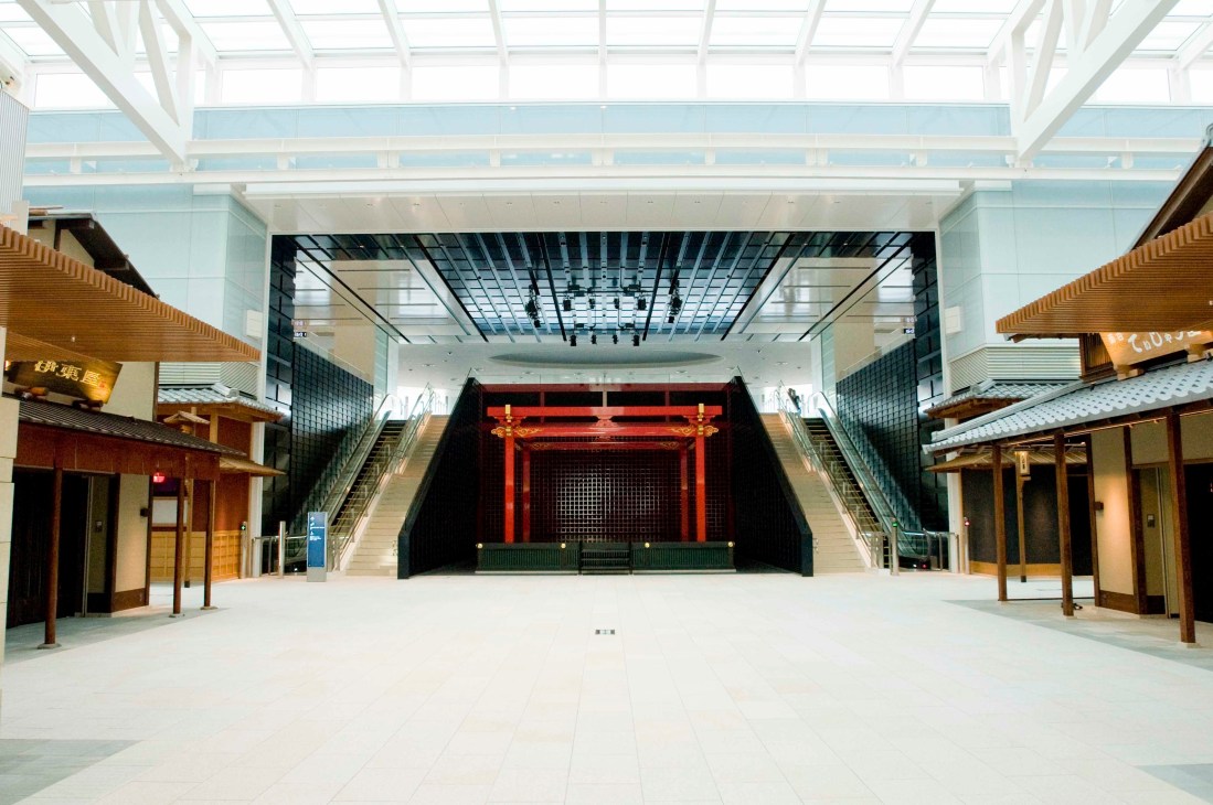 Edo Koji retail marketplace at Haneda Airport with traditional Japanese wooden storefronts, red gate, and modern glass ceiling.