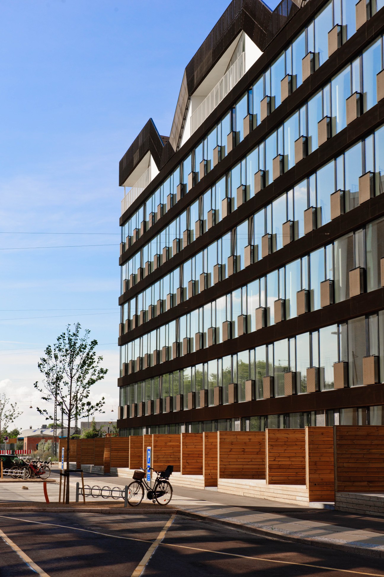 Stay Hotel building facade in Copenhagen with geometric windows and wooden screening panels.