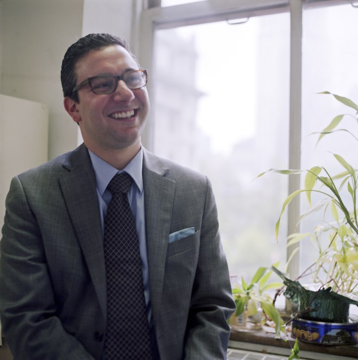 Michael Marrella, director of Waterfront and Open Space Planning, smiling in an office with a potted plant.
