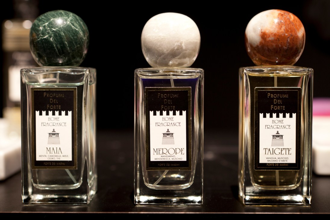 Three Profumi del Forte perfume bottles with marble stoppers in green, white, and red tones.