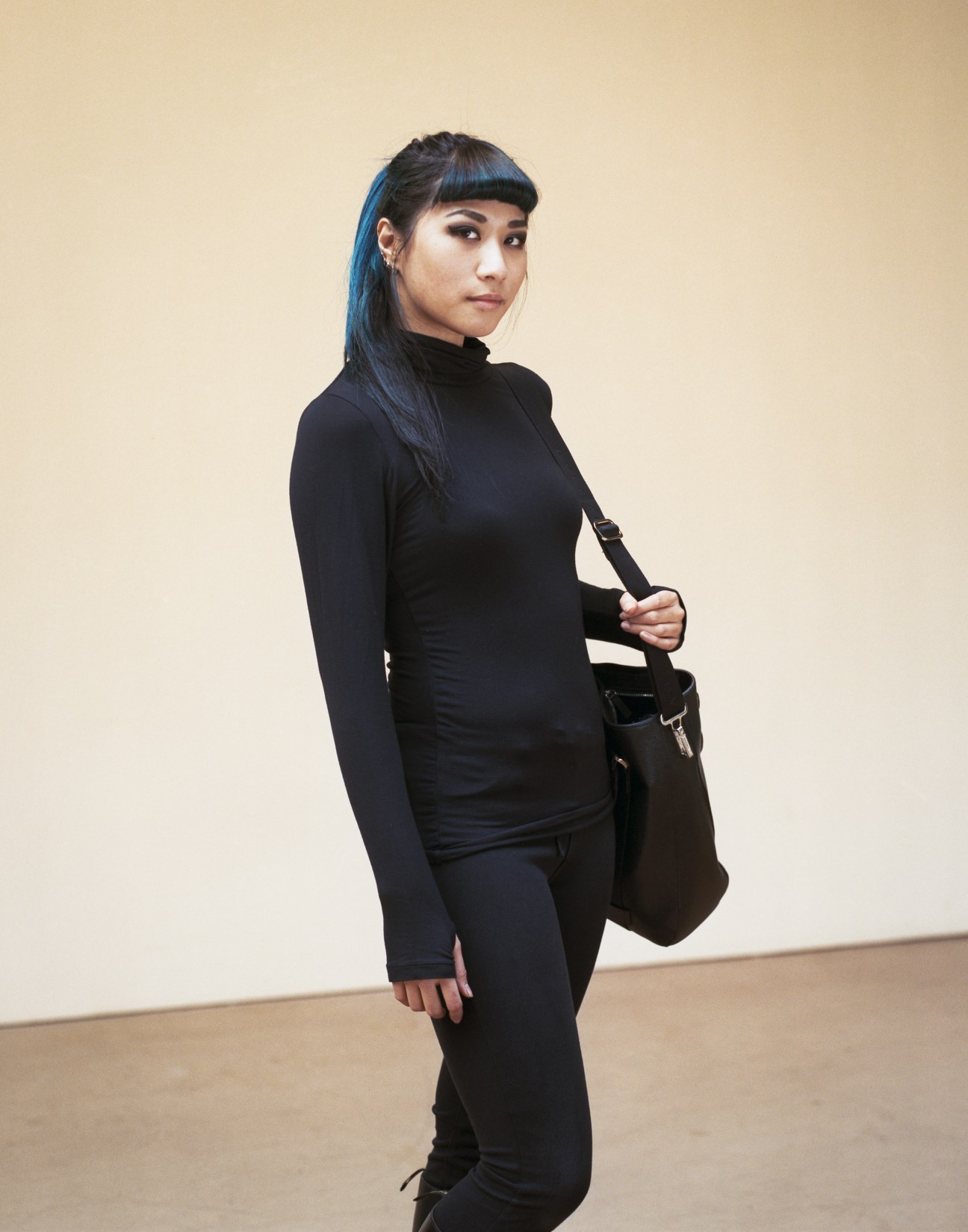 Jazz Chen, a BA Fine Art student from Taiwan, poses in black clothing against a beige background.