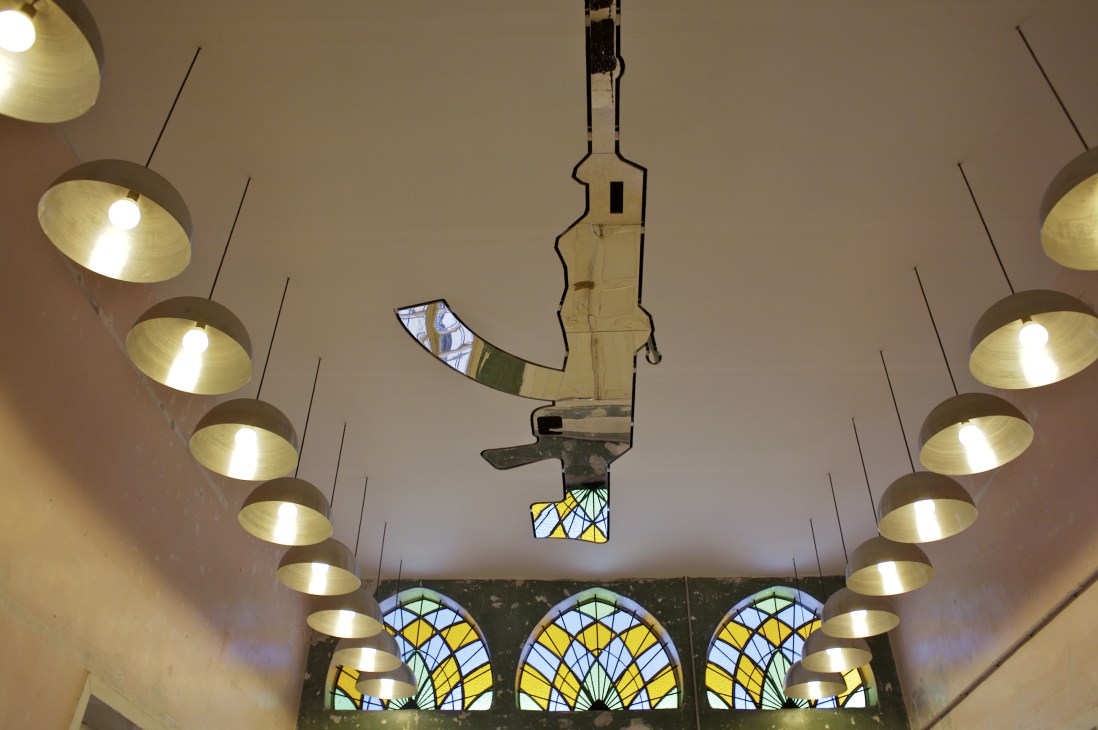 Ceiling of the Comme des Garçons Guerrilla store featuring brass pendant lamps and stained glass windows designed by architect Riad Kamel.