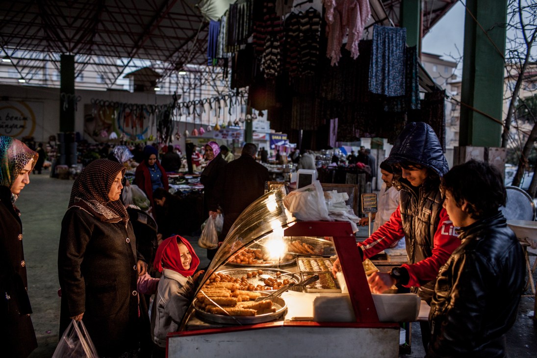Customers browse pastries at a baklava stall in Gaziantep's covered market