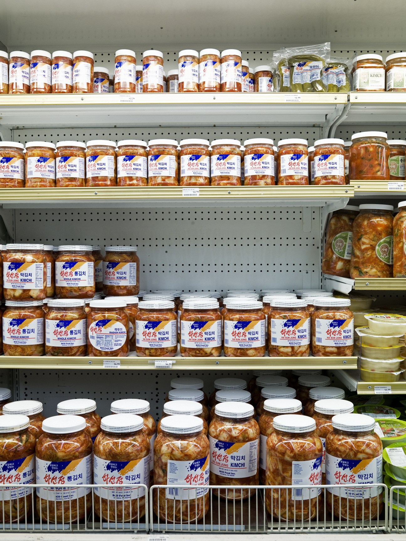 Shelves stocked with jarred kimchi and Korean condiments at Little Tokyo Market.