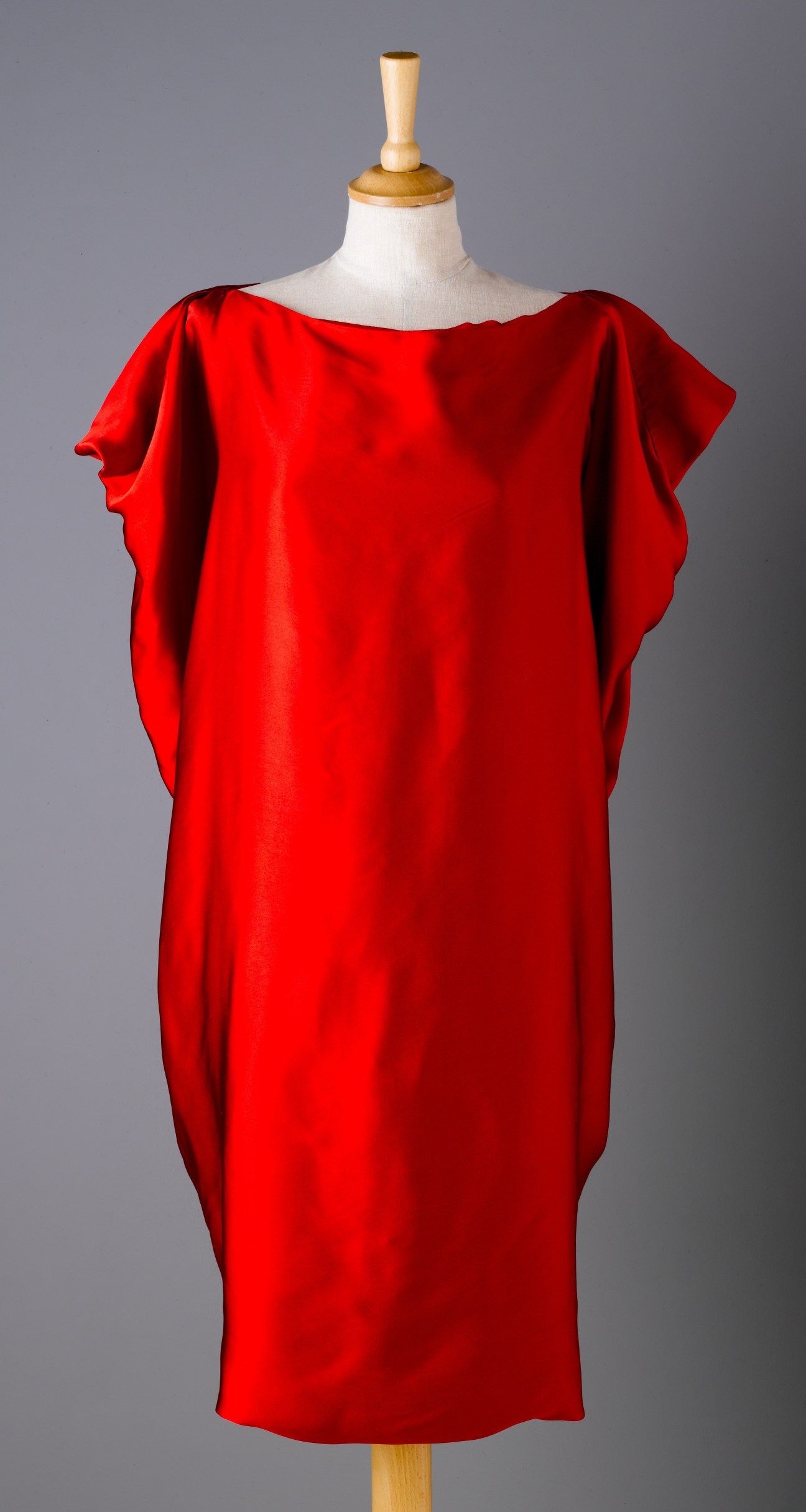 Red double-satin silk couture dress by Rabih Kayrouz displayed on a mannequin.