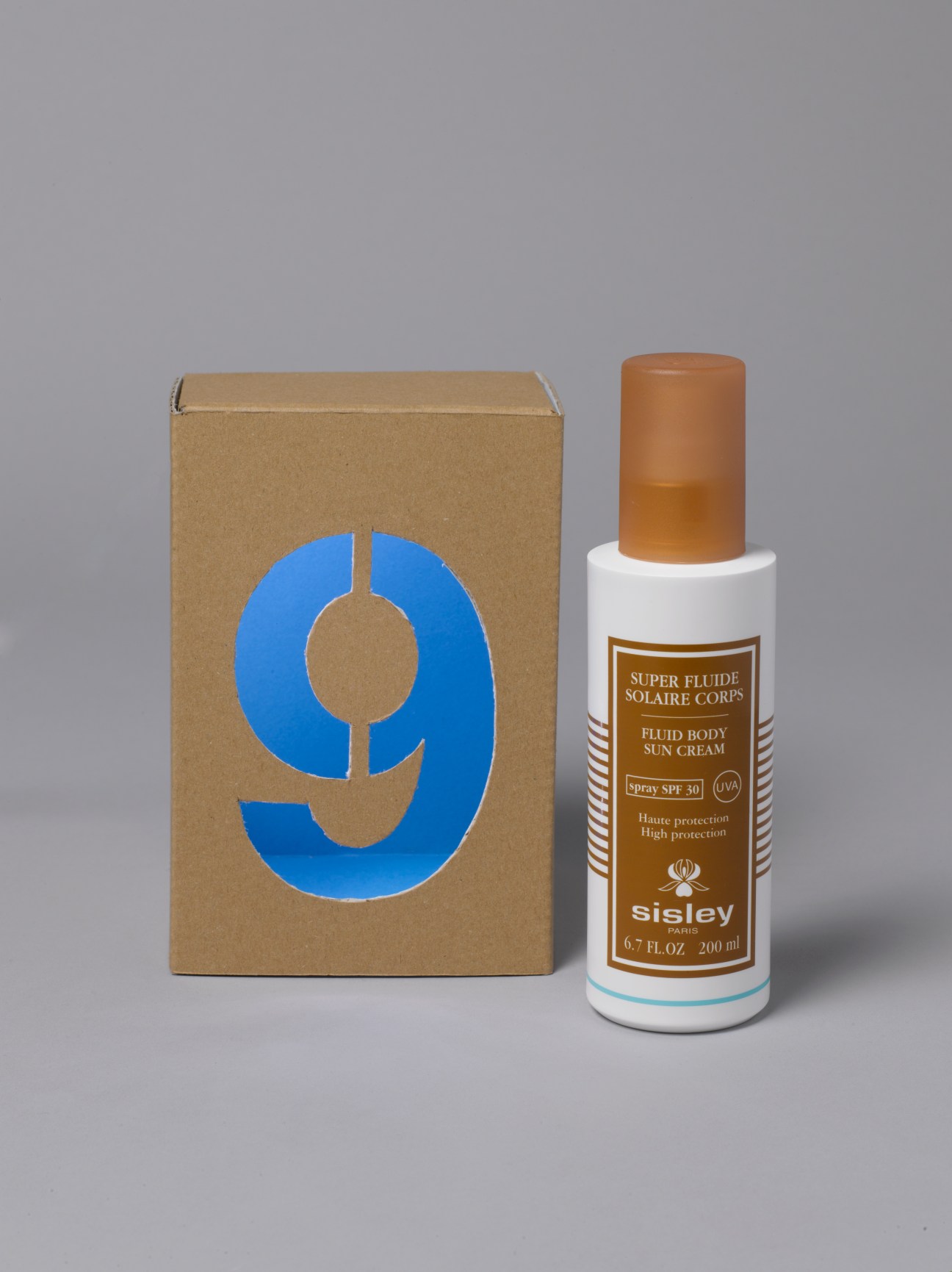 Sisley sun cream spray bottle with packaging box numbered 9.