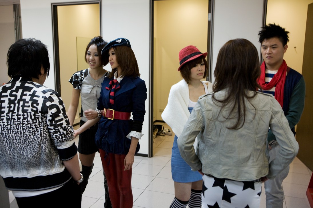 One Million Star contestants mingle backstage in a green room before performing.