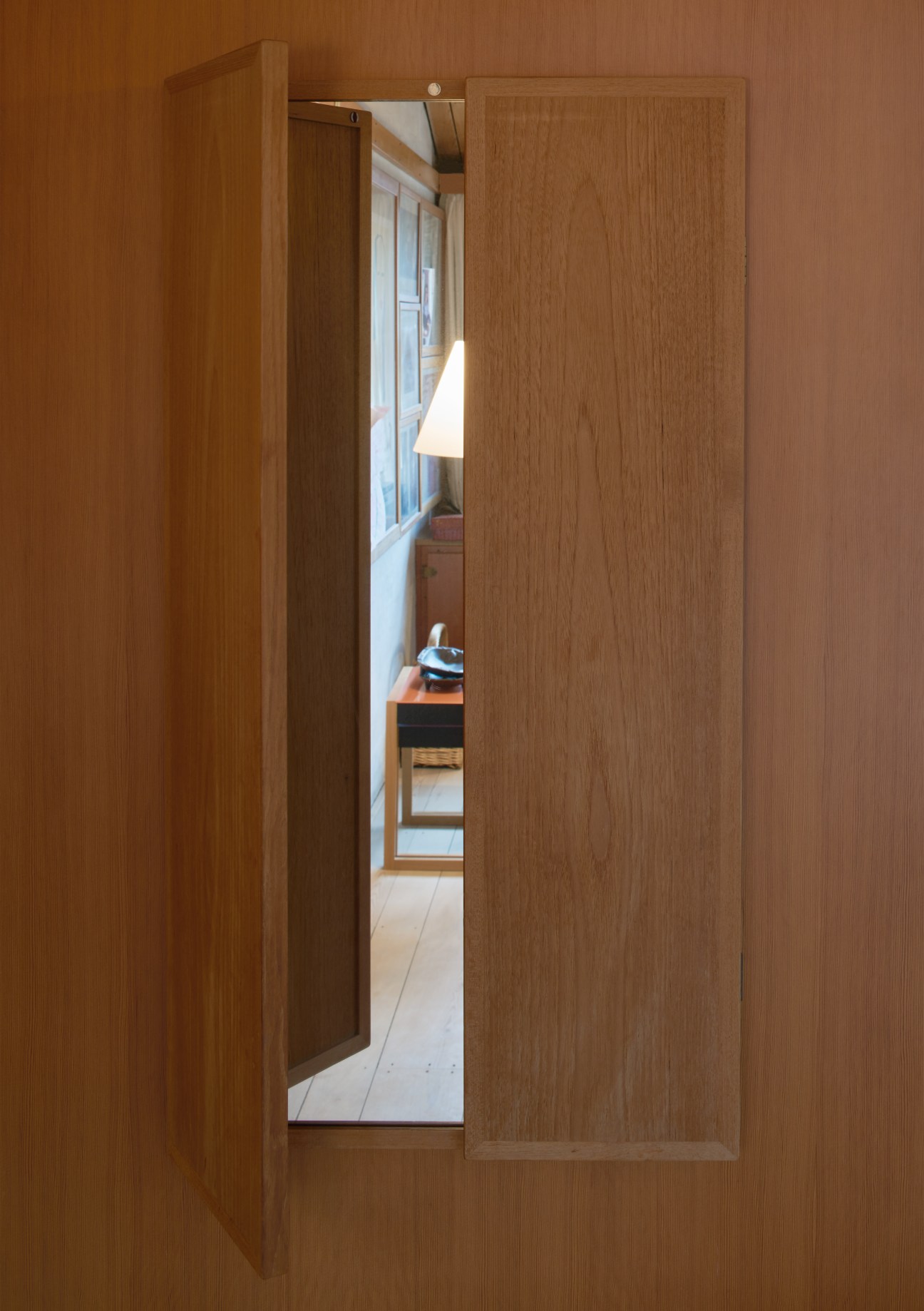 Built-in wooden wall mirror set into oak panelling in the kitchen of Børge Mogensen's house.