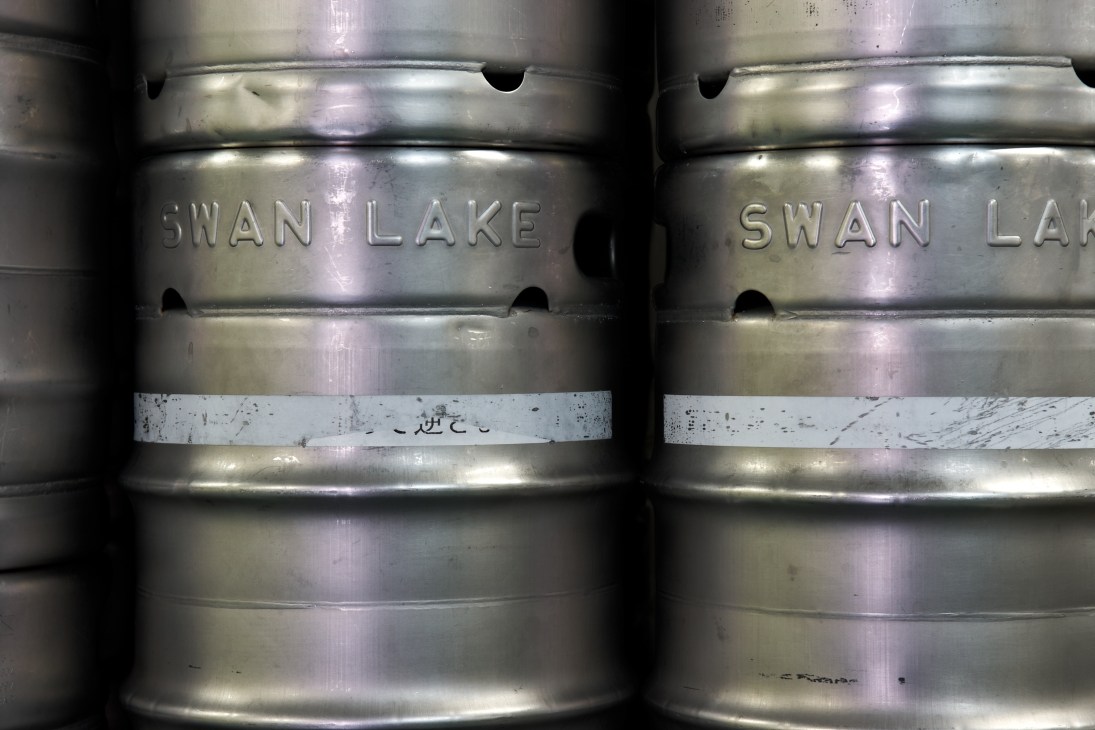 Two metal kegs labeled Swan Lake ready for shipment.