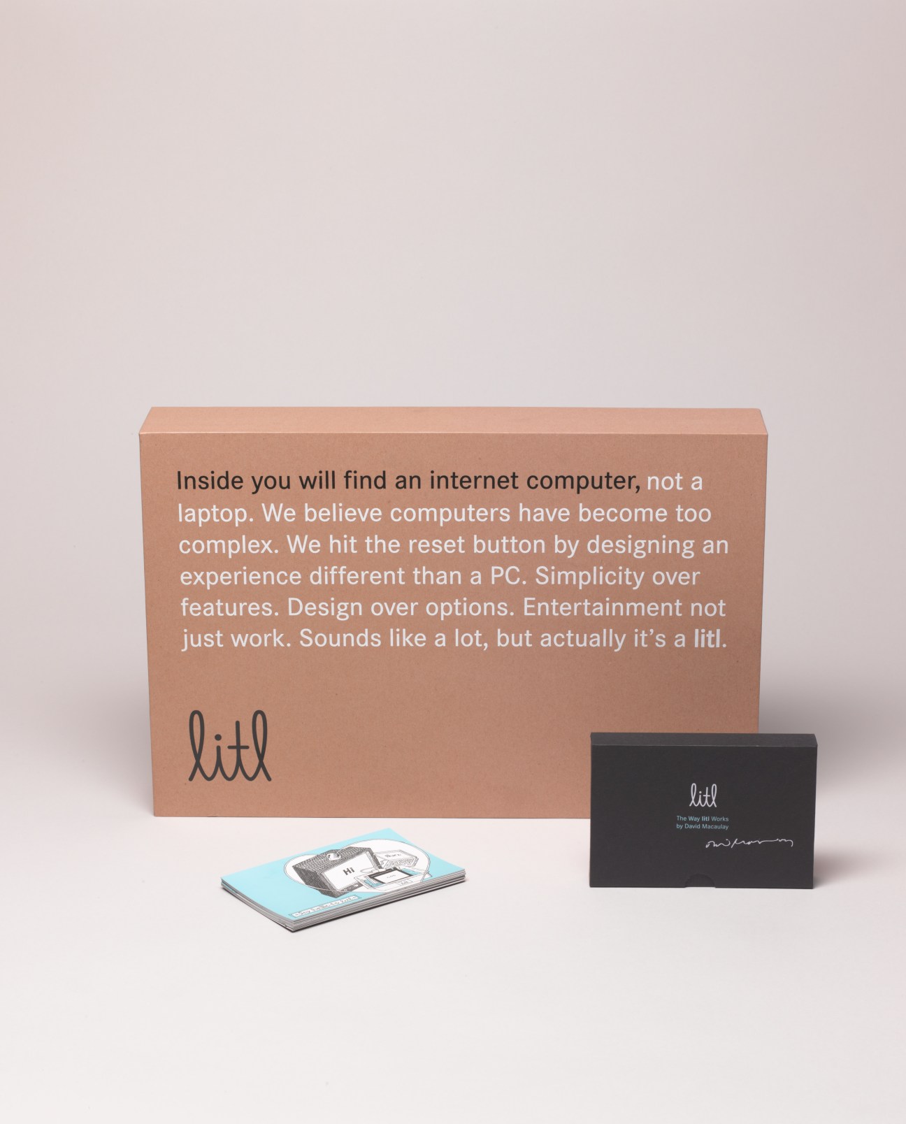 Litl internet computer packaging with recycled cardboard box, instruction cards, and black case on white background.