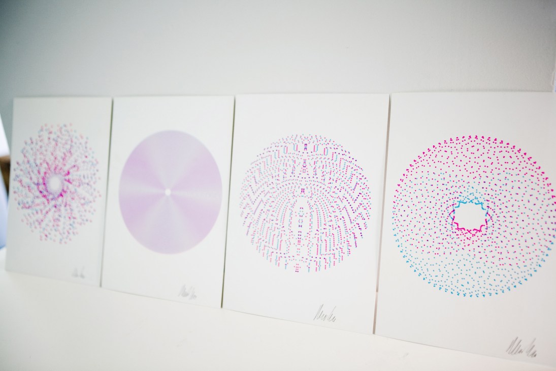 Four framed prints by Michael Cina featuring geometric circular patterns in pink and blue dots on white paper.