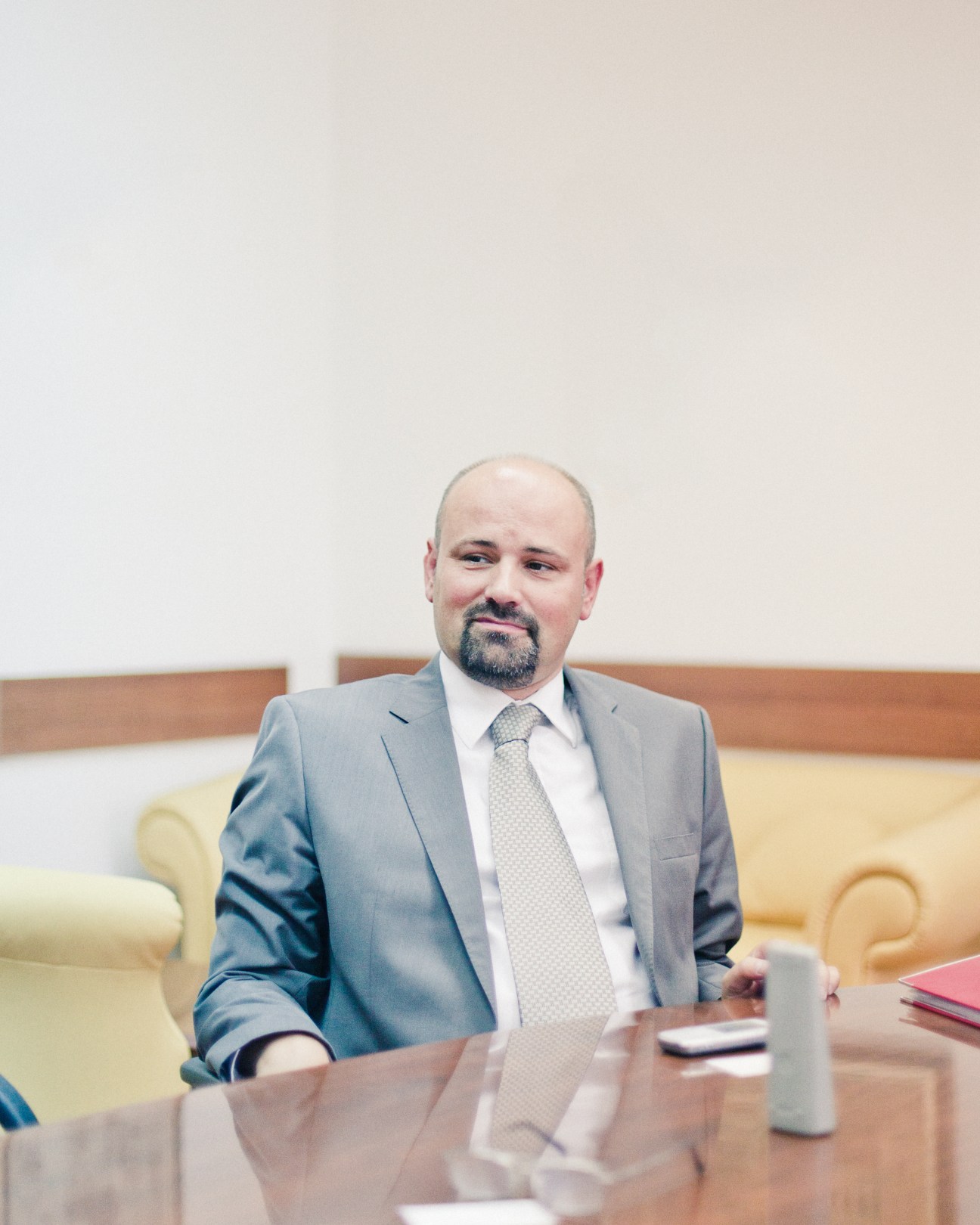 Bruno Vekaric, spokesman for Serbia's war crimes prosecutor, seated at a table in an office setting.
