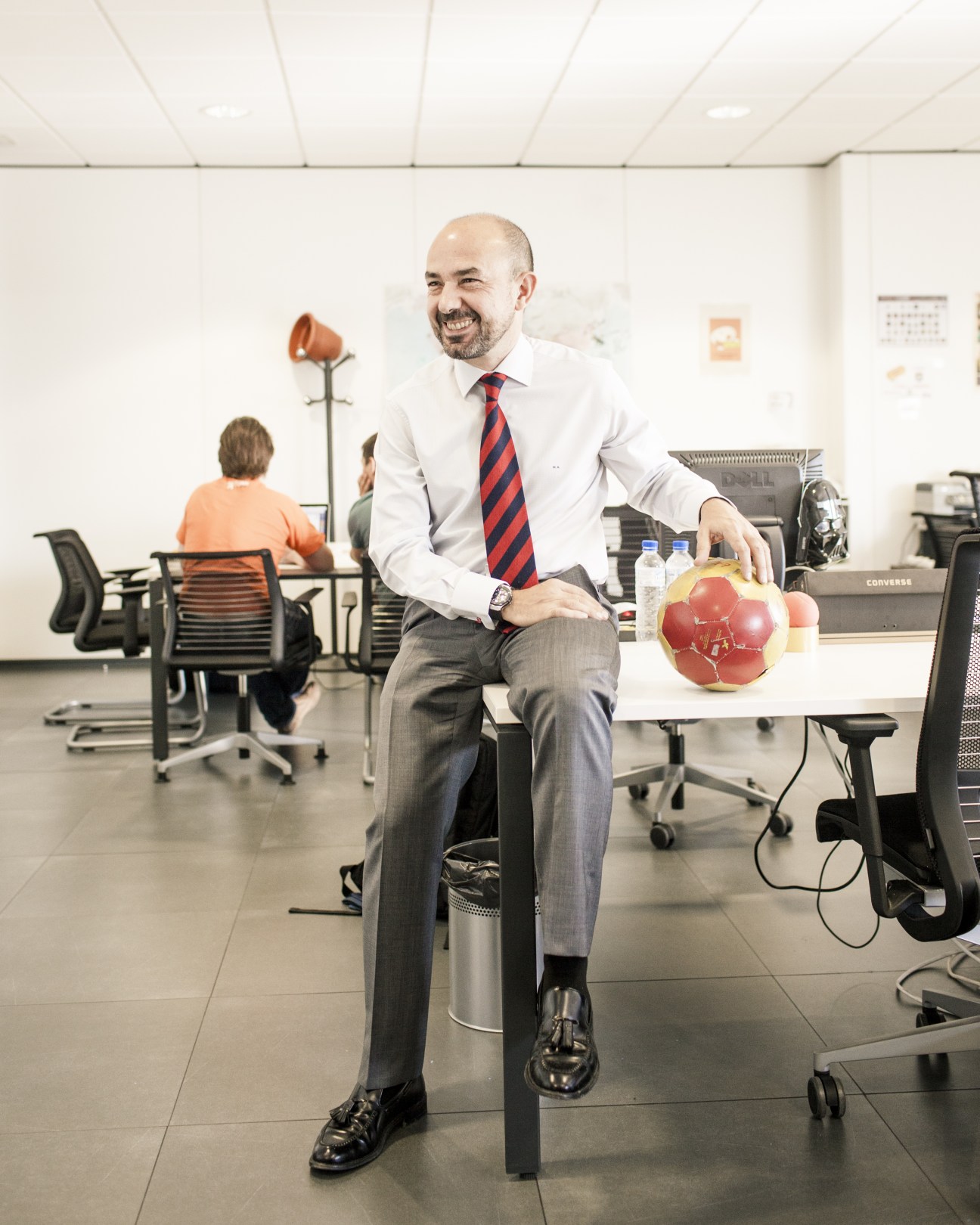 Deputy mayor Miguel Ángel Villanueva sits at a desk in a modern office space with colleagues working in the background.
