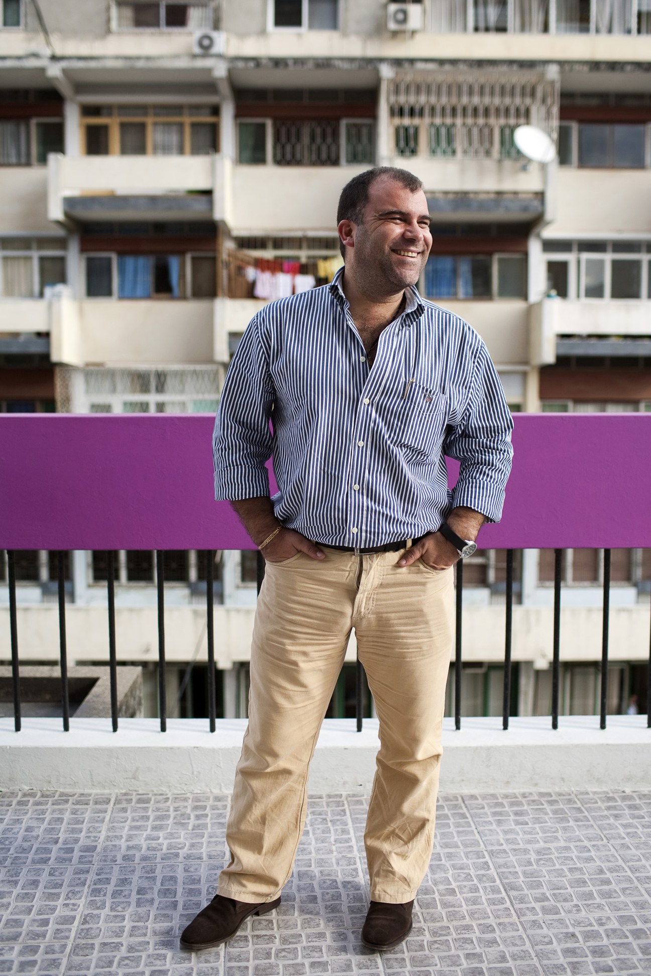 Vasco Rocha of DDB advertising agency stands smiling in front of a modernist apartment building in Maputo.