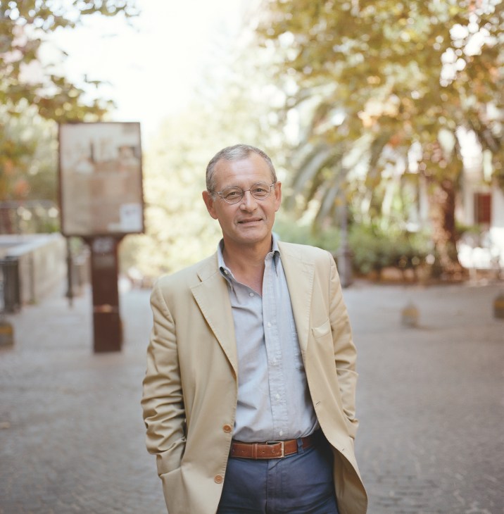 Giuseppe Morgese, a 56-year-old psychiatrist, standing in a tree-lined courtyard in Vomero, Naples.
