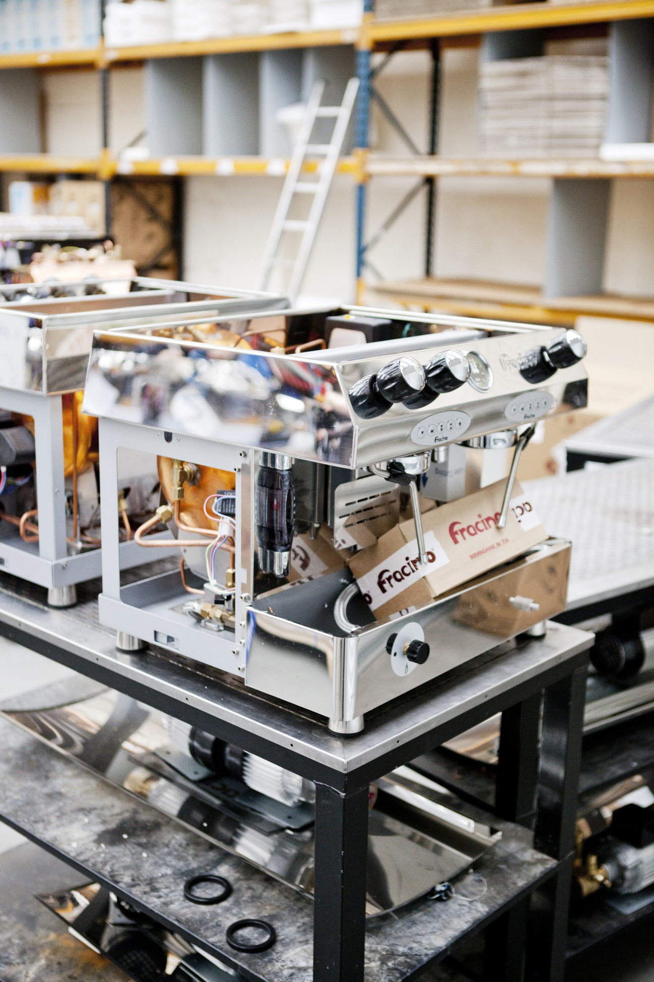 Fracino espresso machine with British branding displayed in a factory workshop.