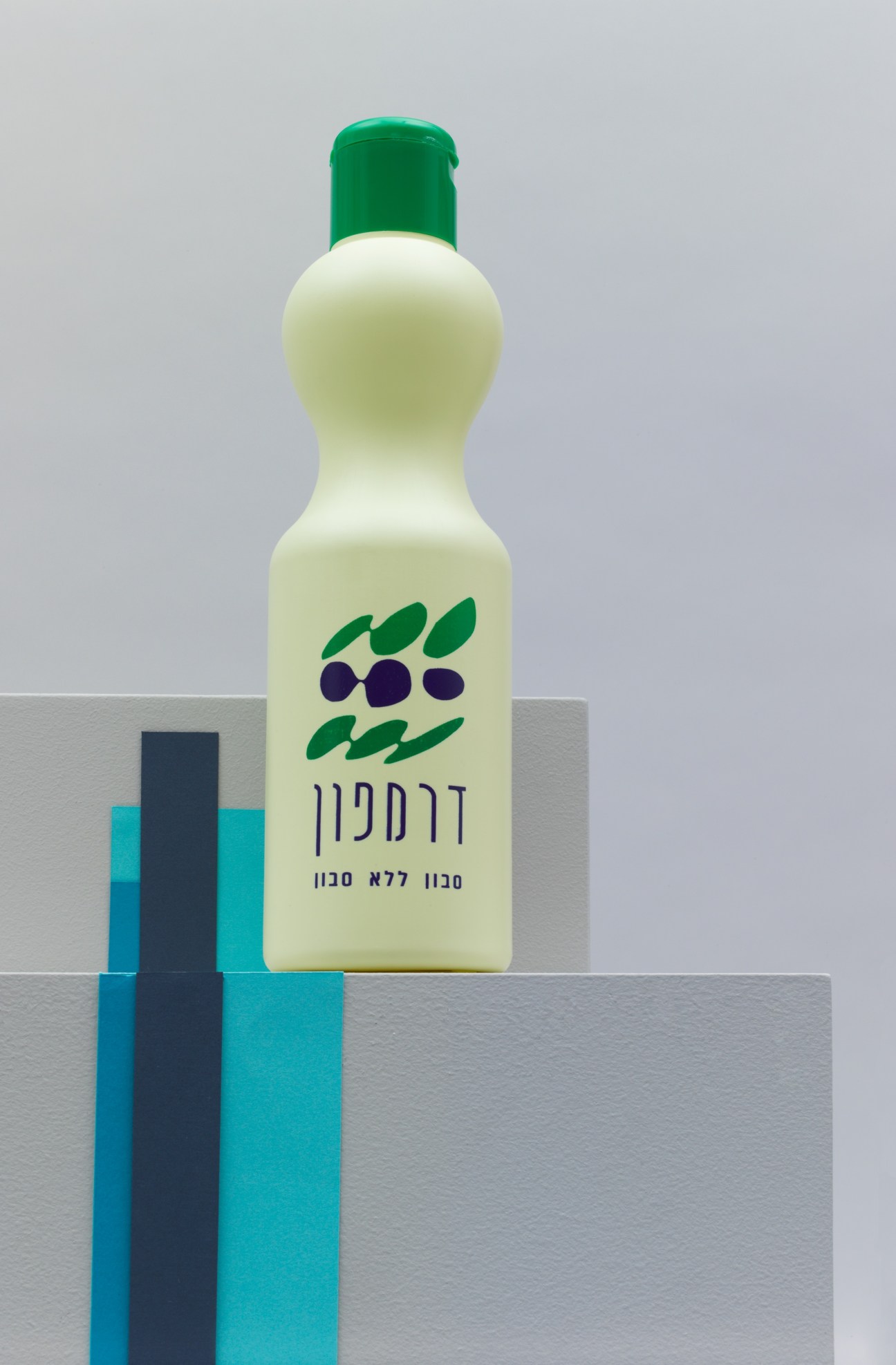 Dermapon soapless soap bottle with cream-colored body, green cap, and Hebrew text on label.