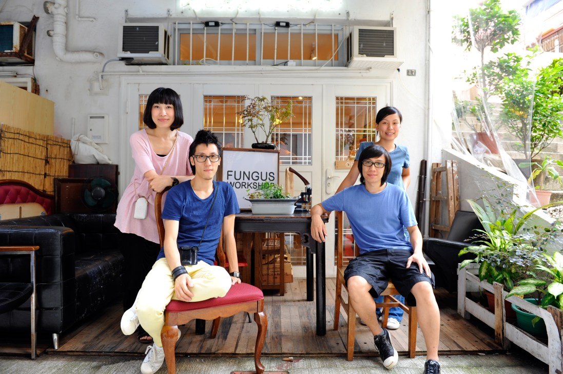 Four people posing together inside Fungus Workshop, a leatherwork studio in Hong Kong's Sheung Wan neighborhood.