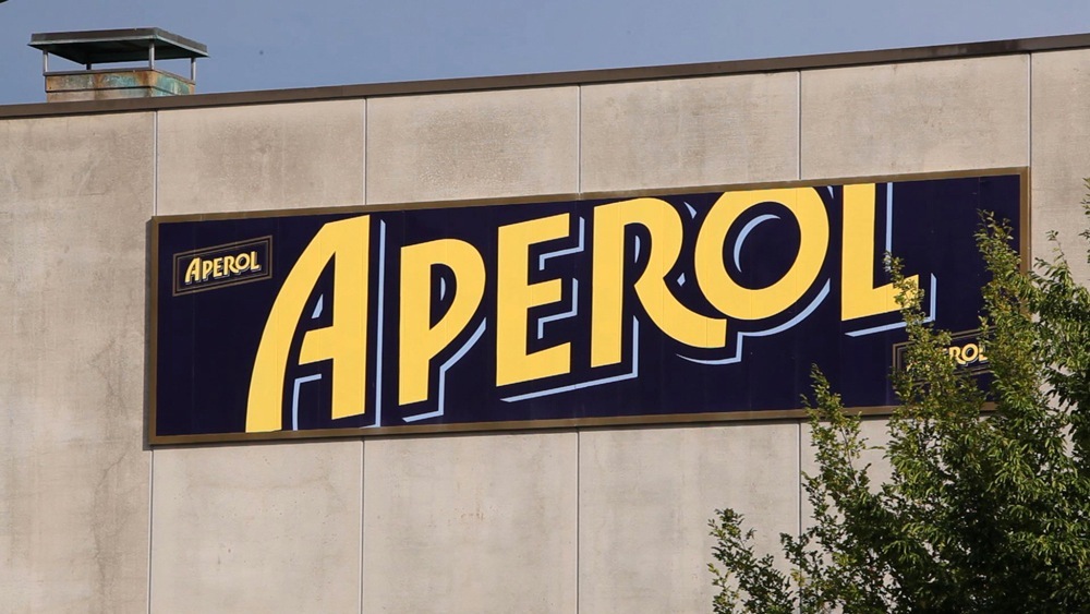 Aperol sign on the exterior wall of the Canale d'Alba bottling plant
