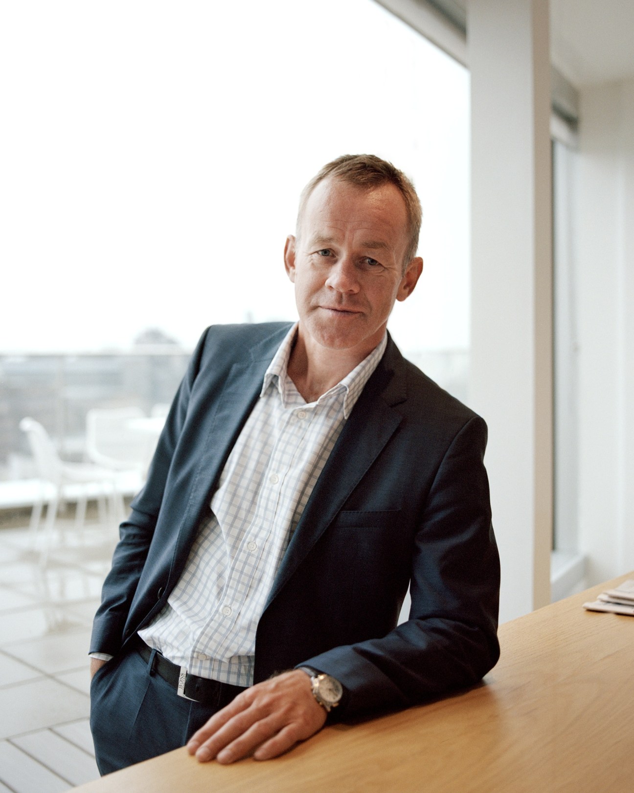 Editor-in-chief and publisher Amund Djuve poses at his desk overlooking Oslo.