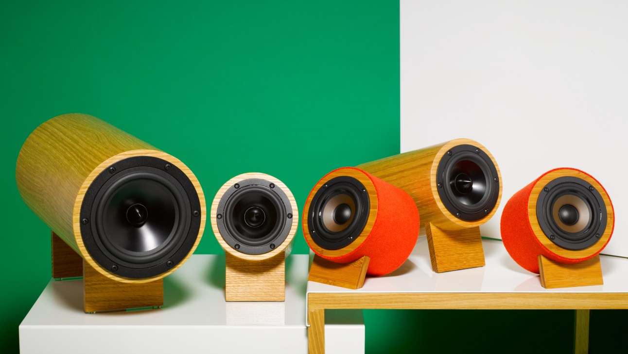 Well Rounded Sound Inc wooden speakers in various sizes with black speaker cones and red wool felt covers.