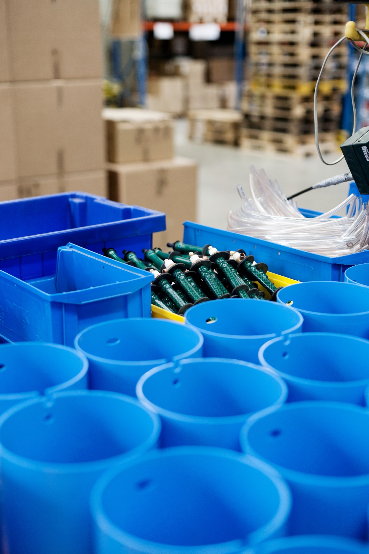 Blue plastic components and green brush parts being assembled at the Spülboy factory in Wuppertal, Germany.