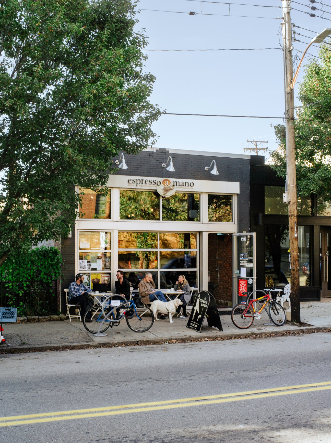 Espresso a Mano coffee shop on Butler Street in Lawrenceville with customers seated outside.