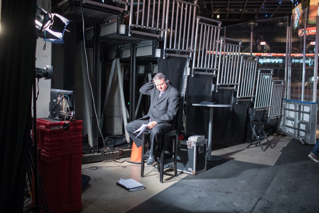 Mark Schadenberg of Rogers TV sits in broadcasting booth surrounded by equipment and cables