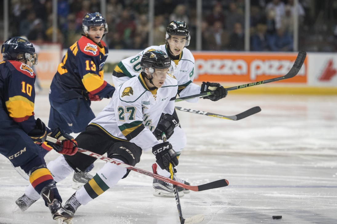 Hockey players Robert Thomas and Alex Formenton skating on ice during game action