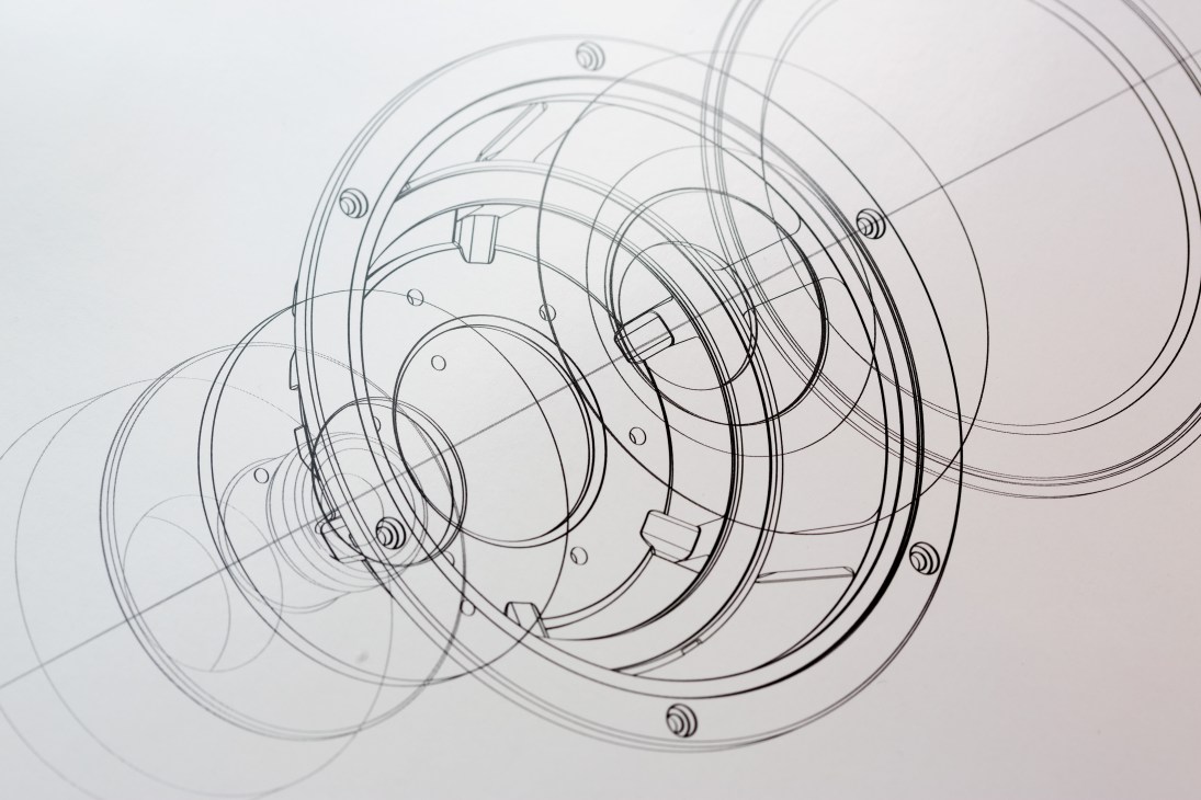 Technical drawing of a speaker component showing concentric circular rings with mounting points and internal mechanisms.