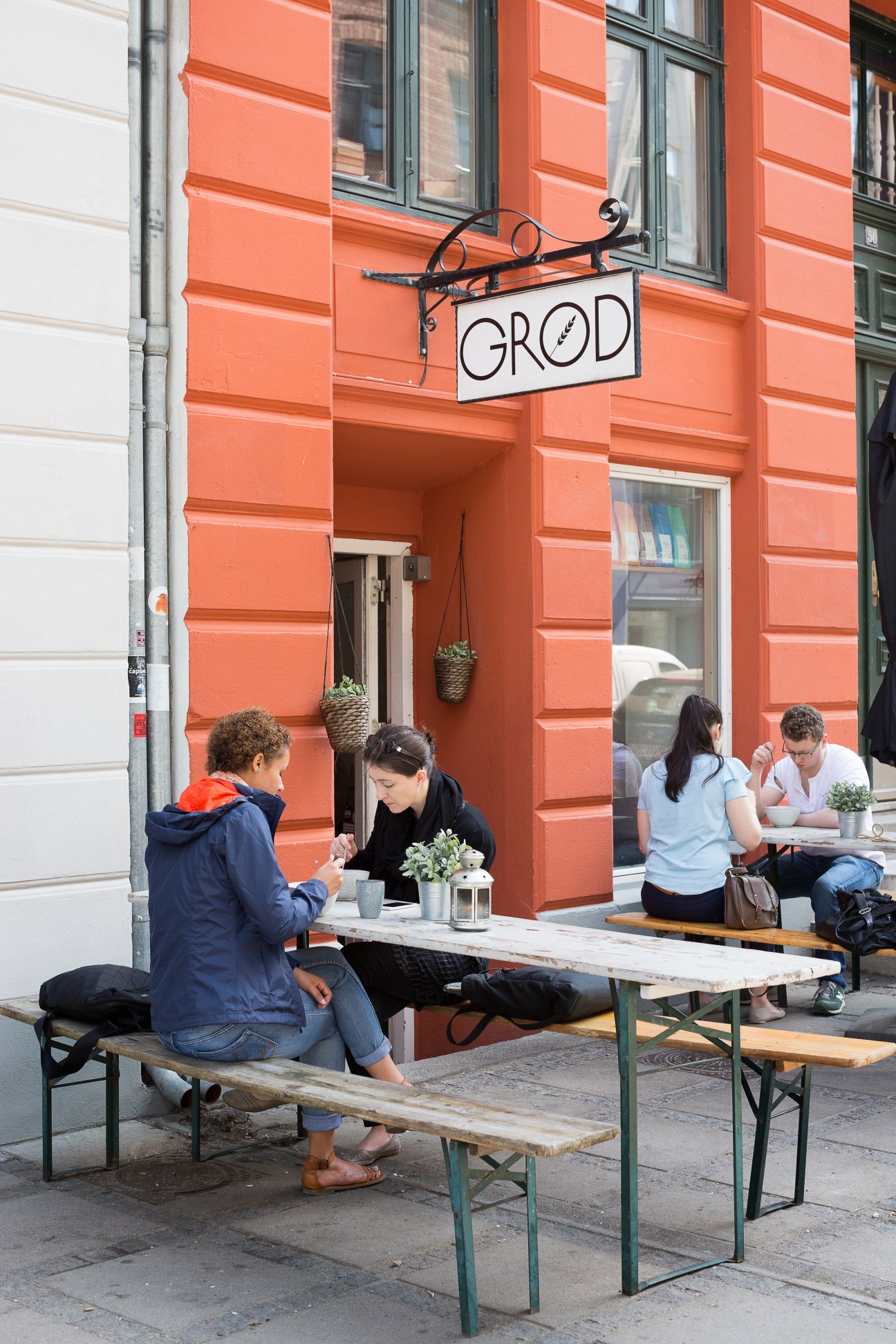 People dining outside Grød porridge bar on Jaegersborggade in Copenhagen