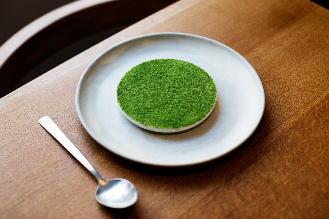 Plate with matcha powder dessert at Relae restaurant in Copenhagen