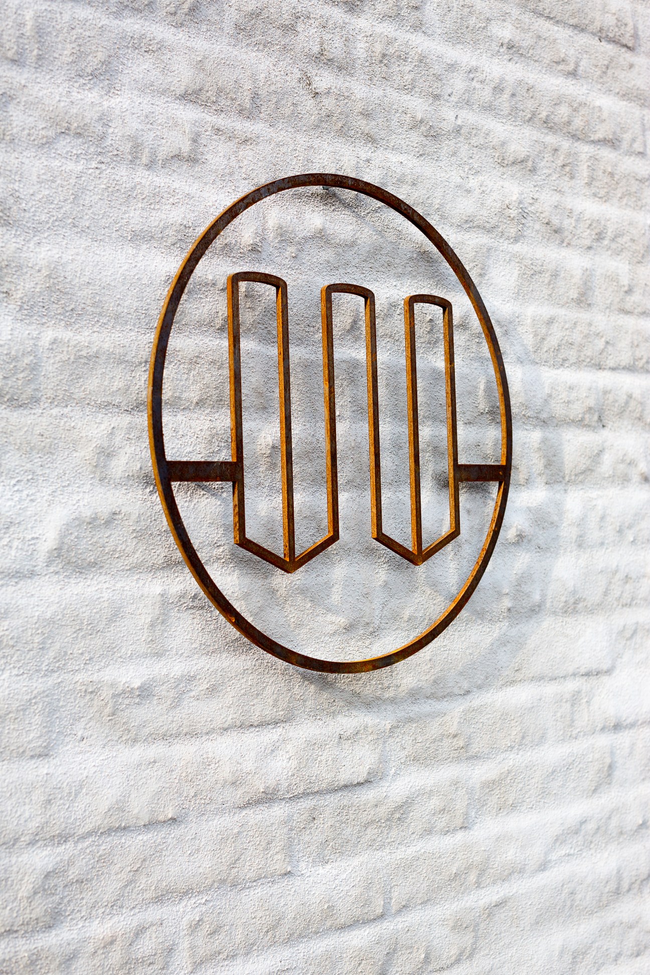 &Tradition emblem mounted on white brick wall