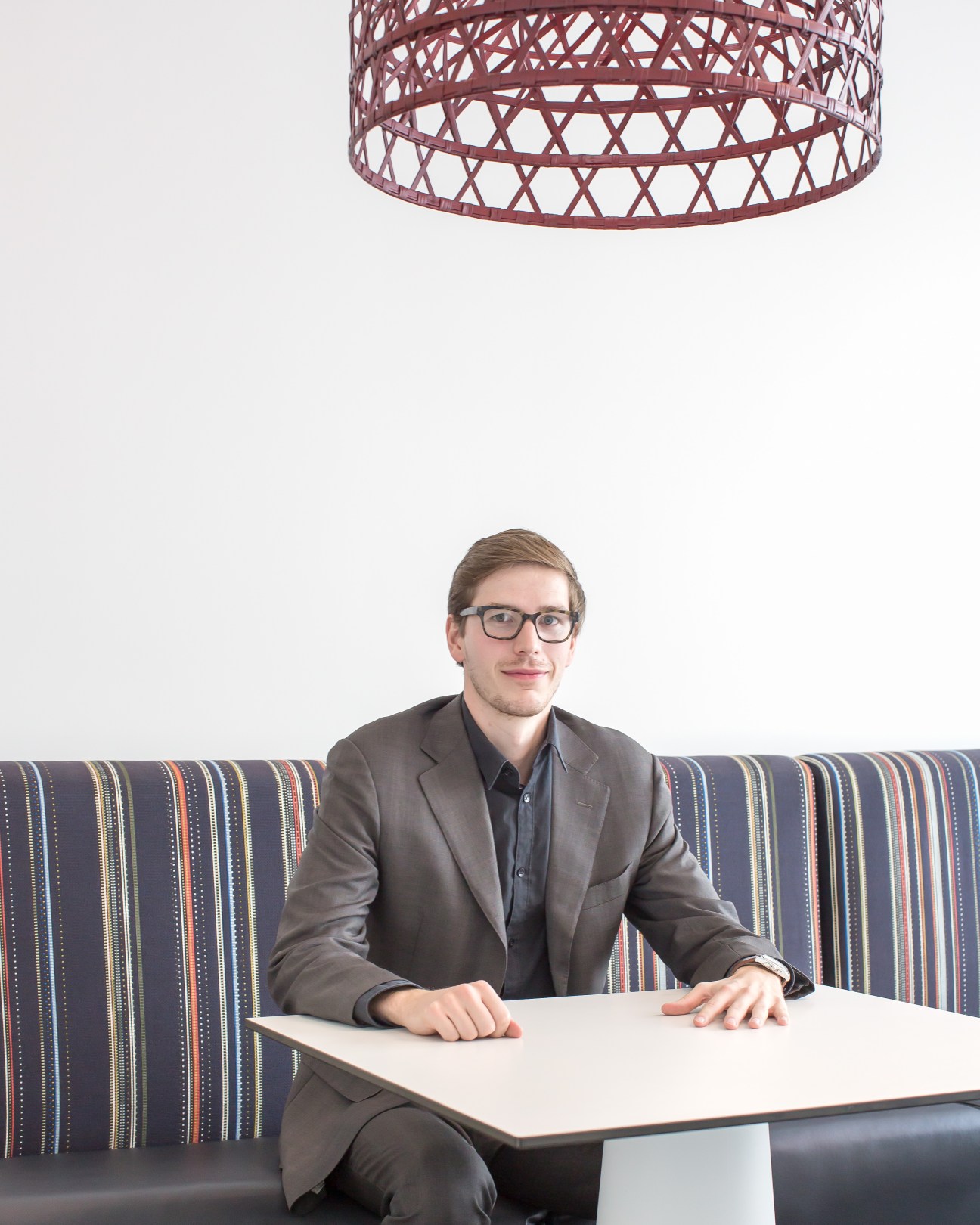 Michiel Roosjen, founder of About Asia, sitting at a table beneath a red lattice pendant light at the Dutch consulate.