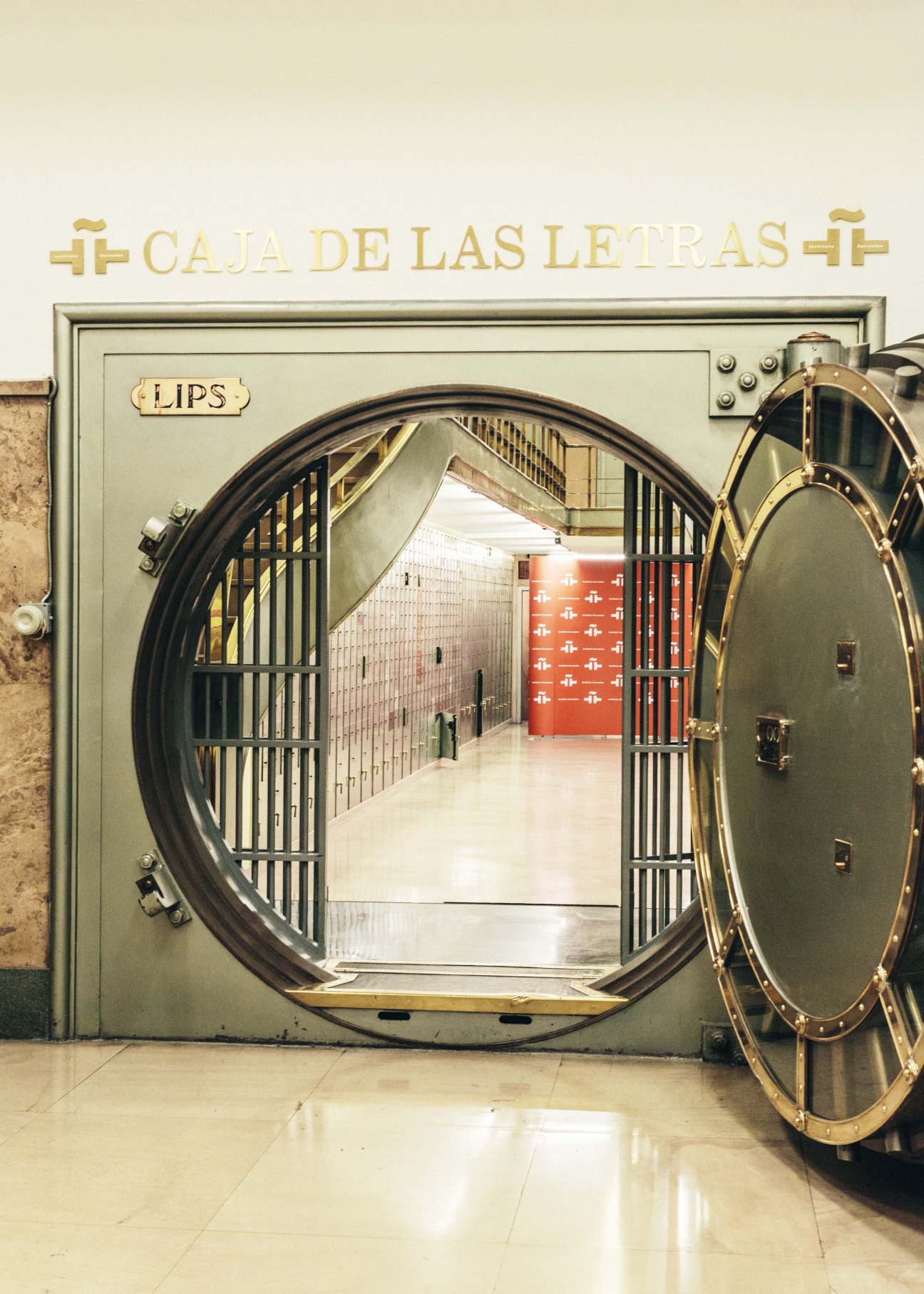 Open circular bank vault door labeled 'Caja de Las Letras' at Instituto Cervantes Madrid HQ.