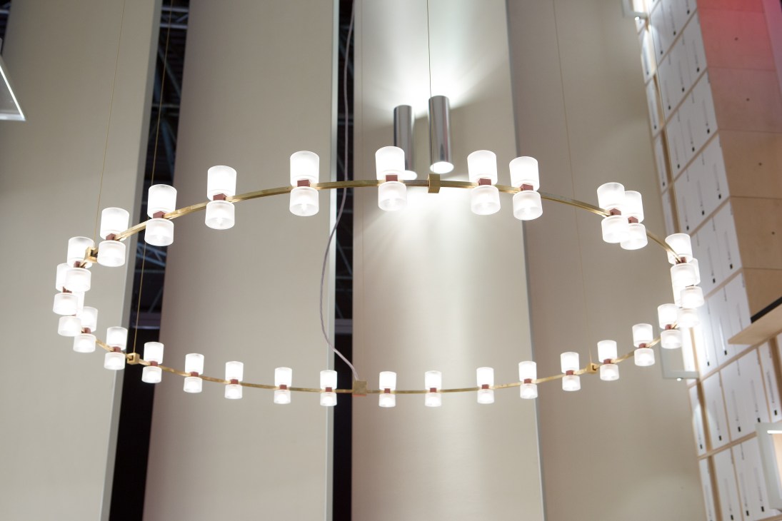 Contemporary chandelier with white cylindrical shades on brass arms designed by Mario Nanni and David Chipperfield.