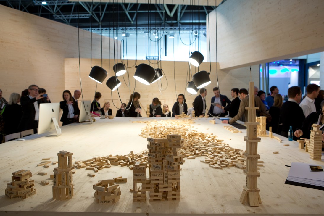 D'Art Design's EuroShop stall interior featuring wooden building blocks and pendant lighting.