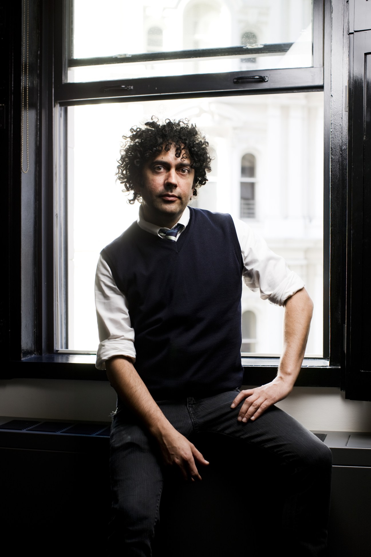 Alex Calderwood, co-owner of Ace Hotel Group, sits by a window at Ace Hotel New York.