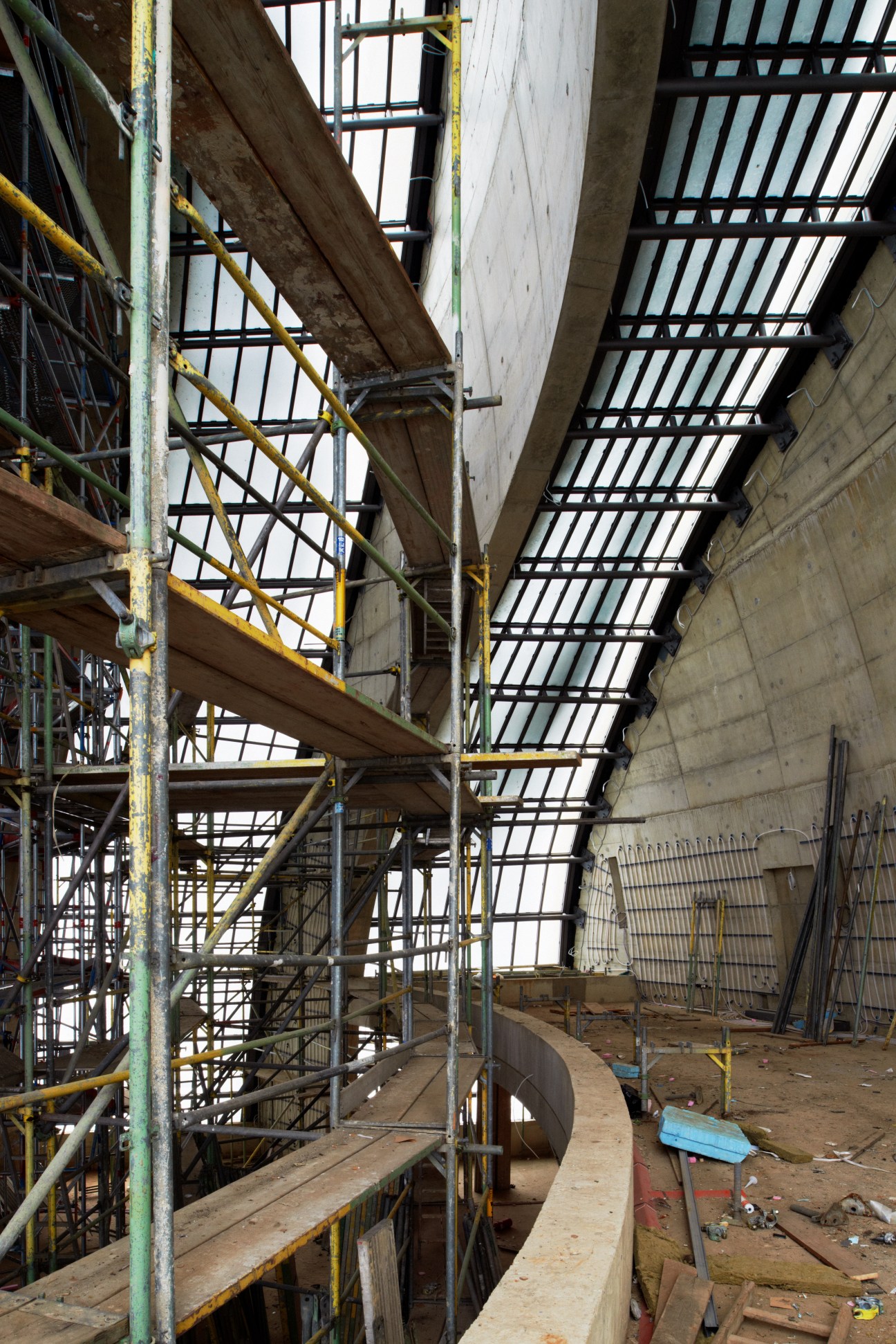 Construction scaffolding and steel framework inside the prayer hall during building work.