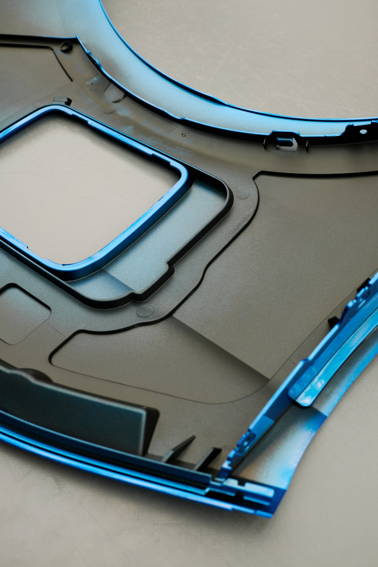 Close-up of freshly painted BMW car parts in Protonic Blue with quality inspection details visible.