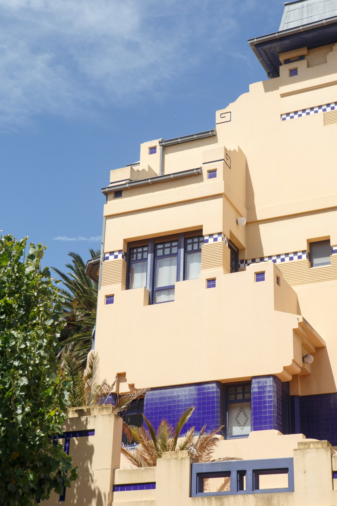 Villa Molina, a cream-colored modernist building with blue tile accents and geometric details designed by architect Rafael González.