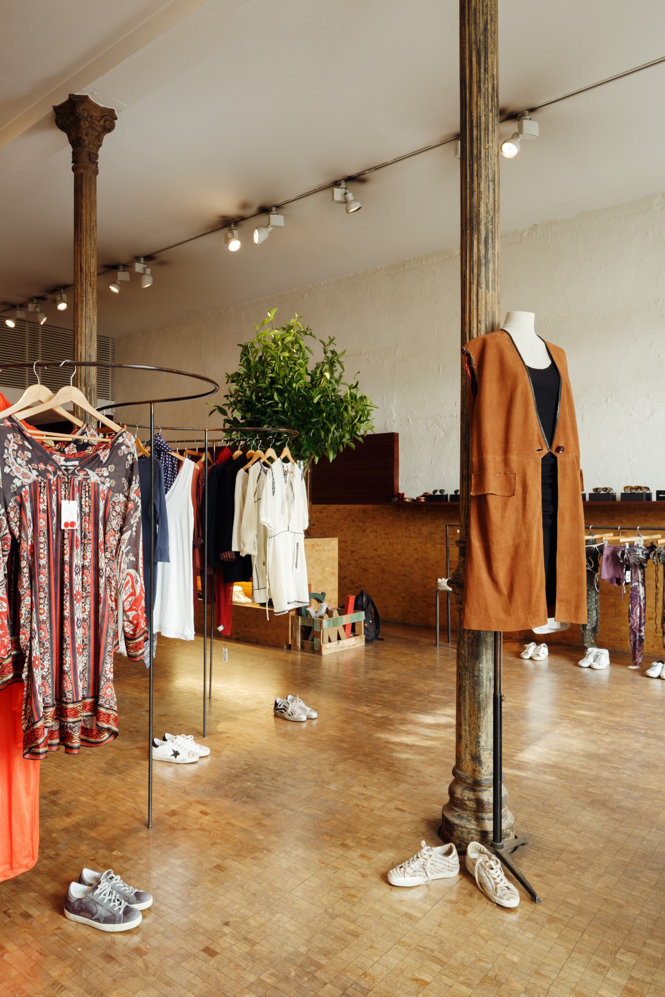 Interior of Mixing multi-brand boutique showing clothing racks and displayed garments.