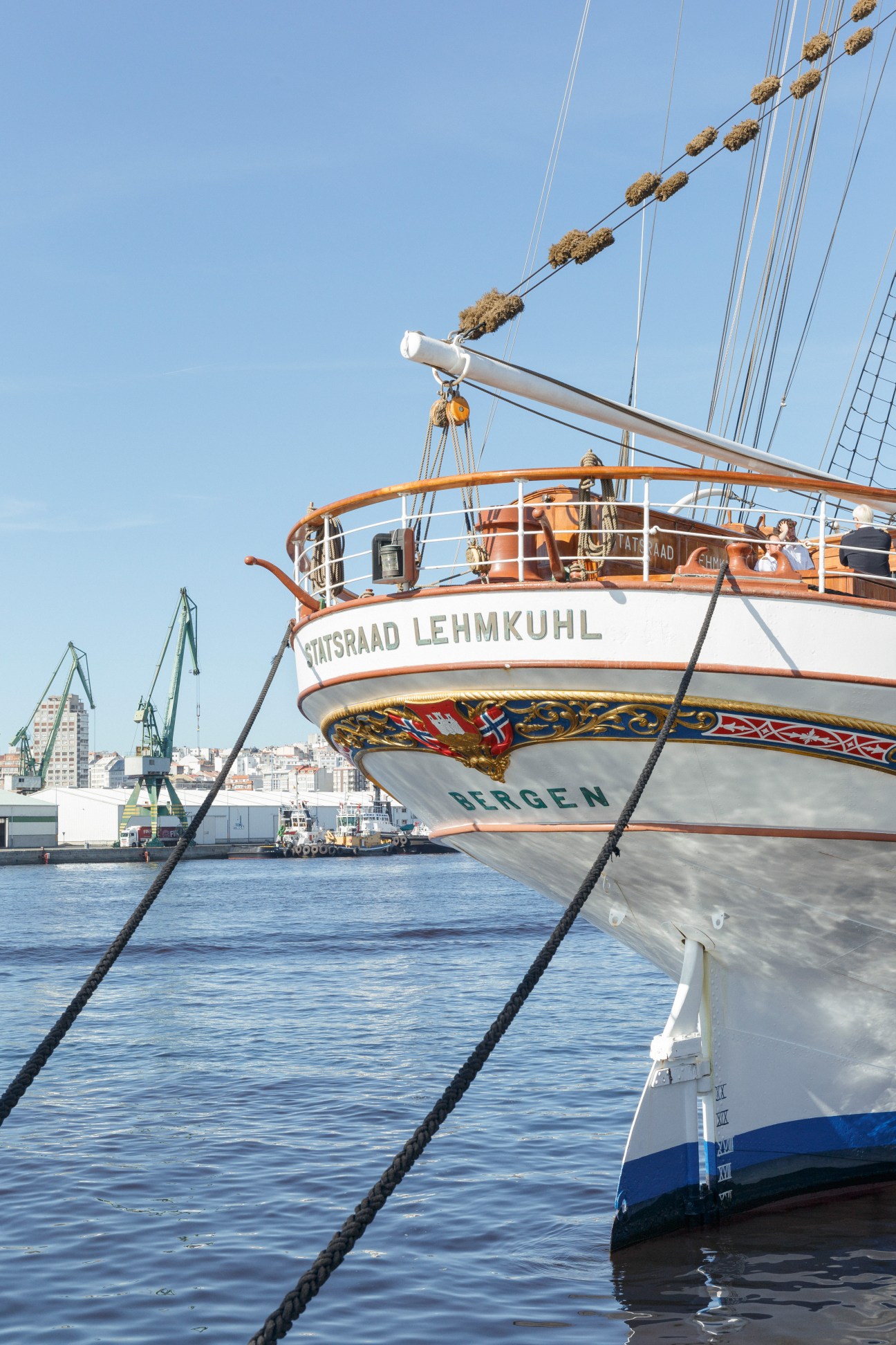 Tall ship Statsraad Lehmkuhl docked in A Coruña port with rigging and cranes visible