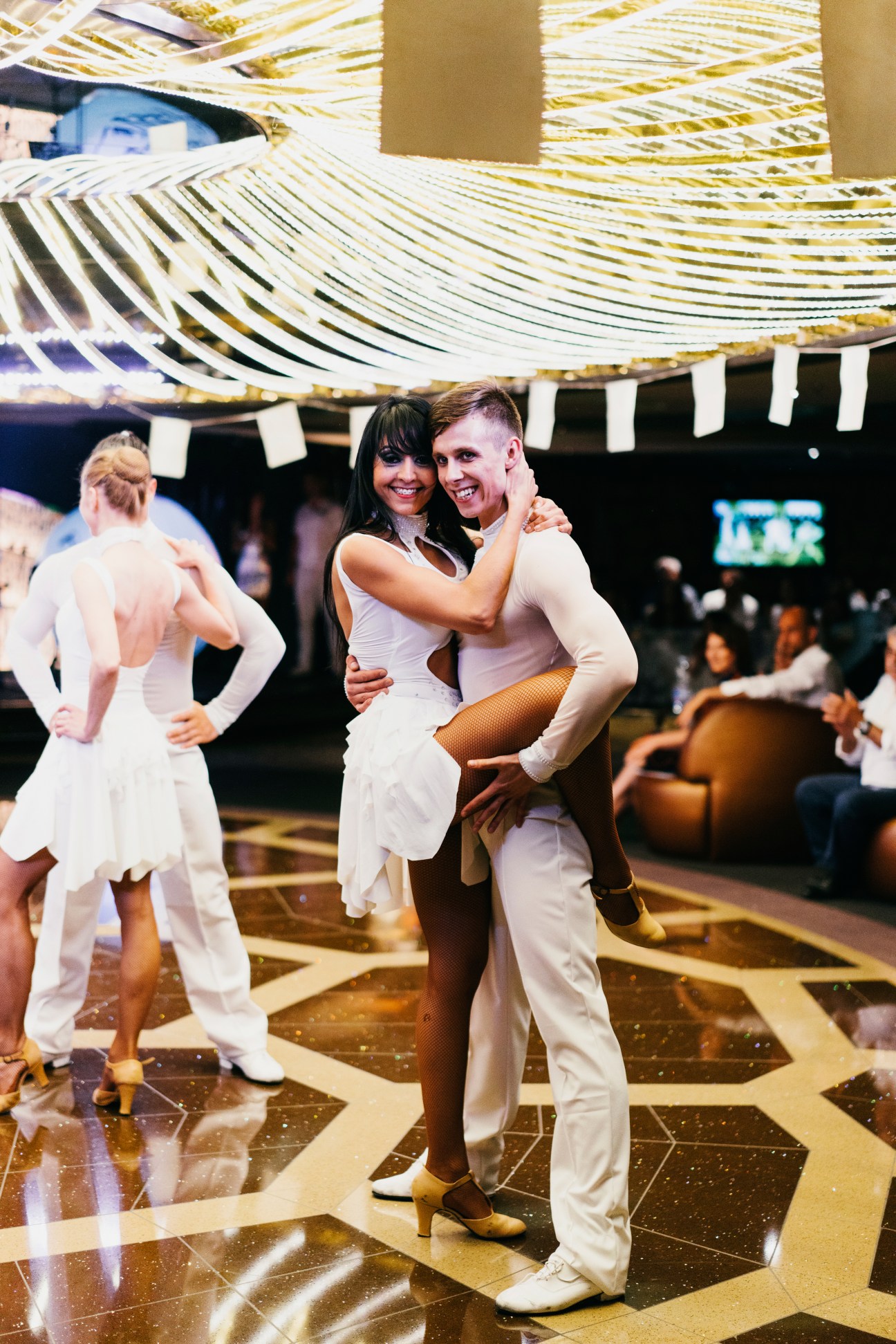 Dancers in white outfits perform at a 'White Night' event on MSC Preziosa cruise ship.