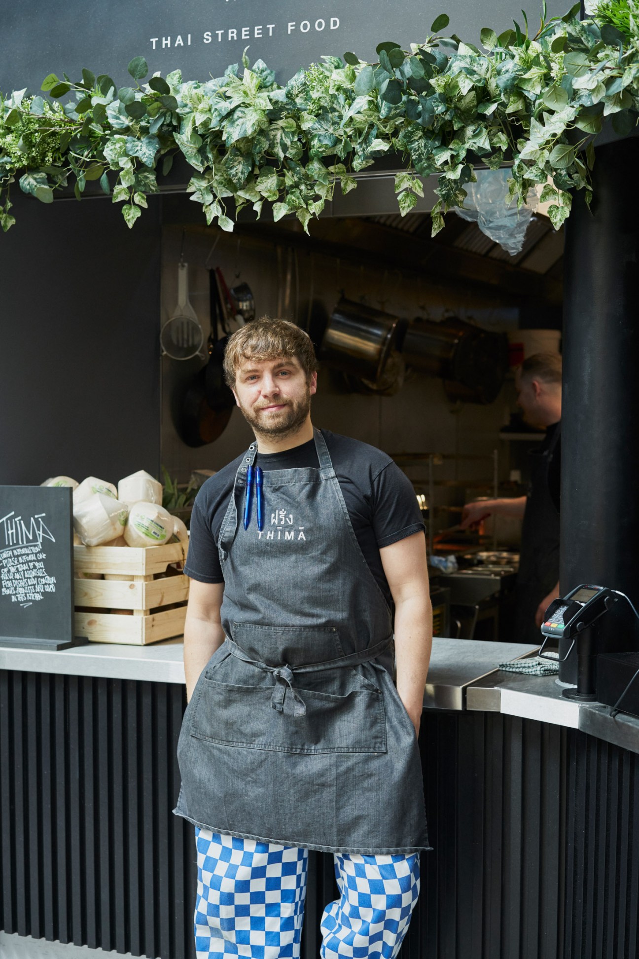 Seb Holmes, founder of Farang, stands at his Thai street food stall at Market Hall Fulham.