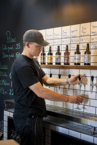Staff member pouring beer from tap at Fanø Bryghus brewery