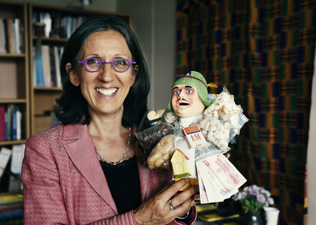 Cécile Duvelle, chief of Intangible Cultural Heritage Section, smiling while holding a decorative figurine in her office.