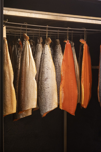 Kitchen towels and aprons hanging on a rack in a restaurant kitchen