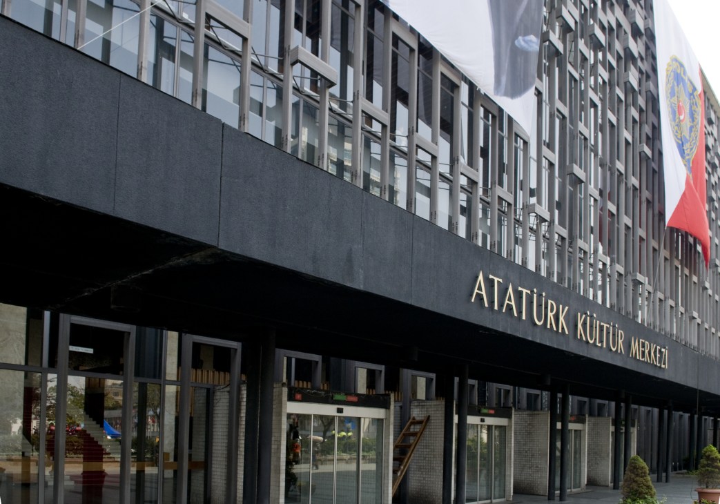 Atatürk Cultural Centre facade with aluminium latticed exterior and signage, Turkish flag visible above.