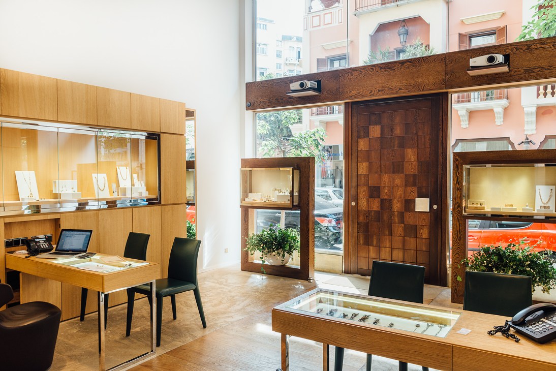 Interior of Selim Mouzannar's jewellery boutique with wooden display cases and glass counters showcasing fine jewellery.
